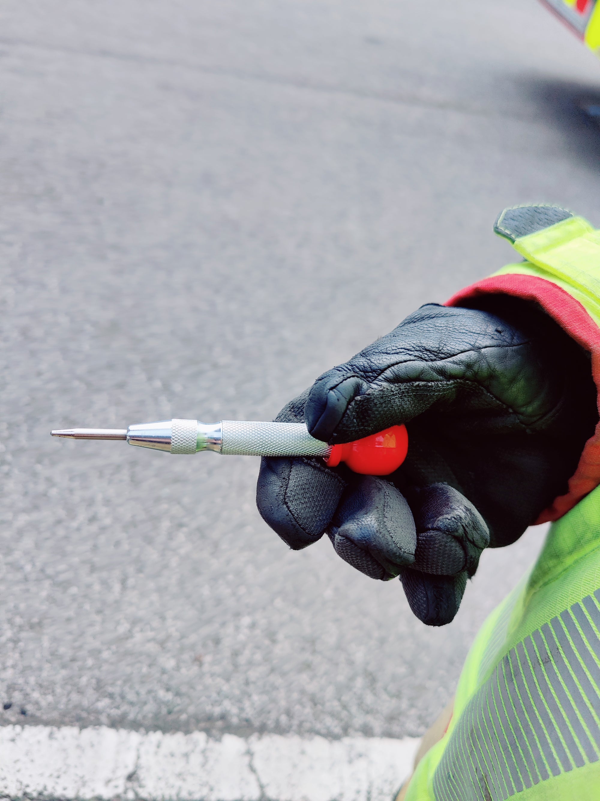 Firefighter holding heavy duty glass breaker punch 
